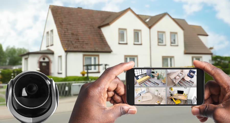 Man holding phone and viewing footage from video cameras
